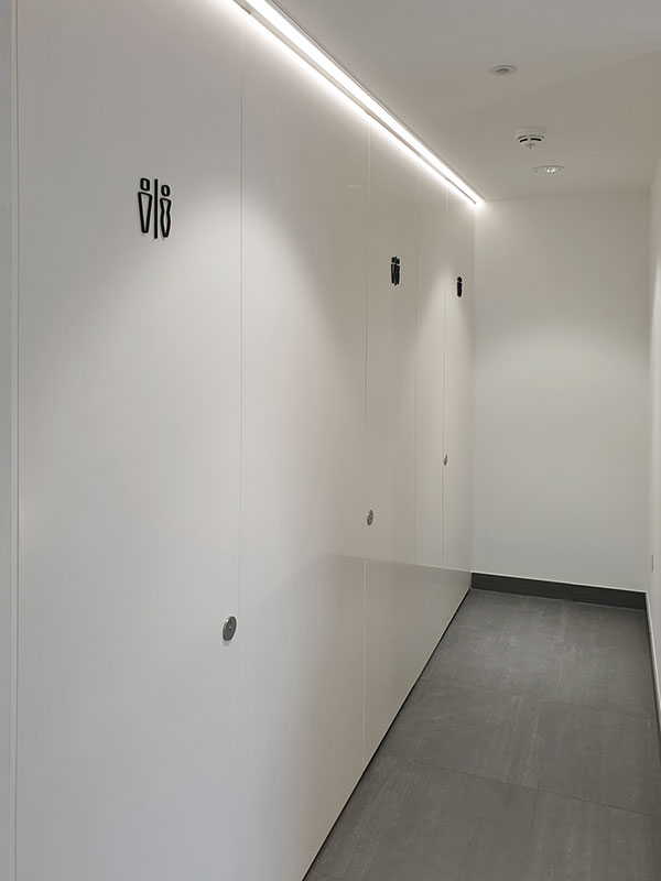 Manufacture and supply of bespoke FSC® certified “Pure White” RAL 9010 factory spray paint lacquered flush rebated washroom cubicle fronts.